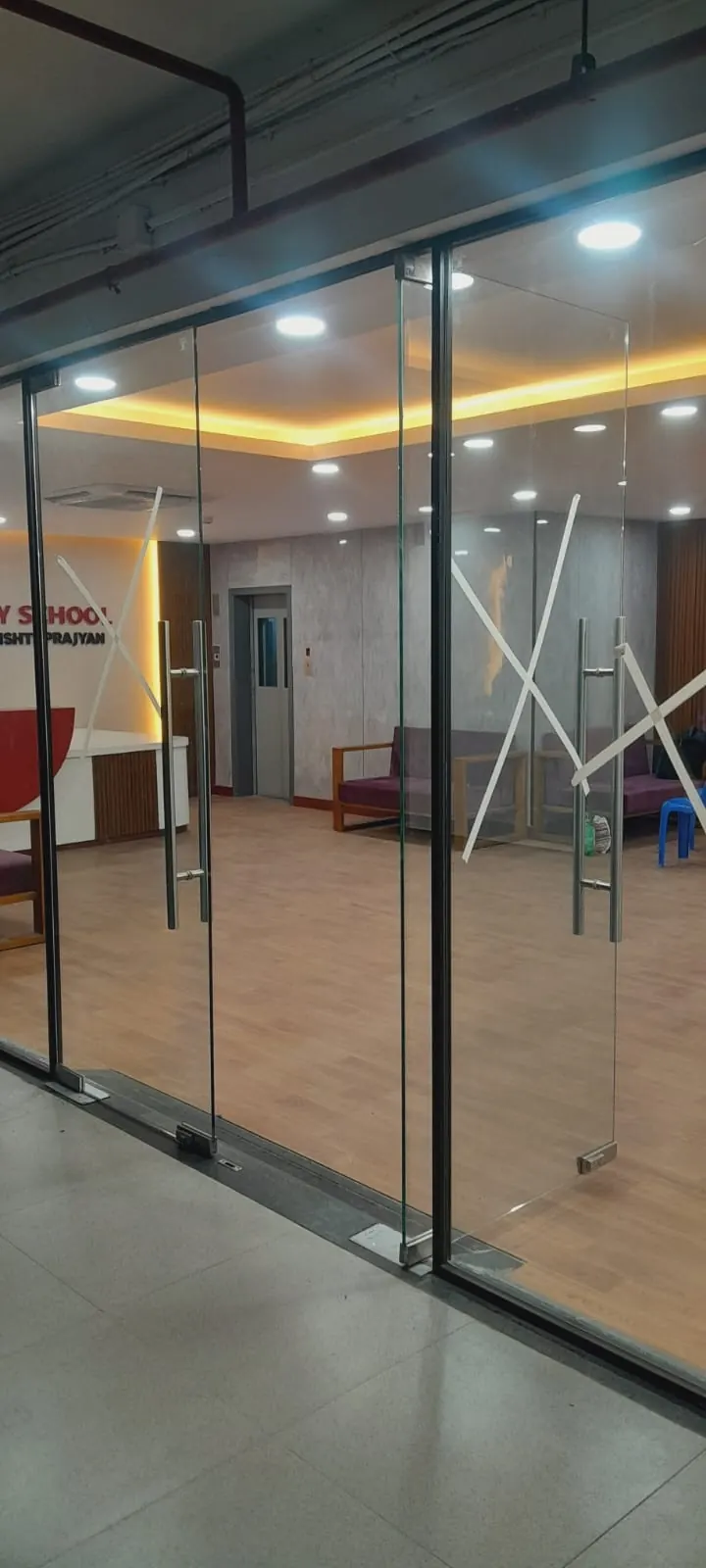 Frameless glass partition and door in a finished office interior