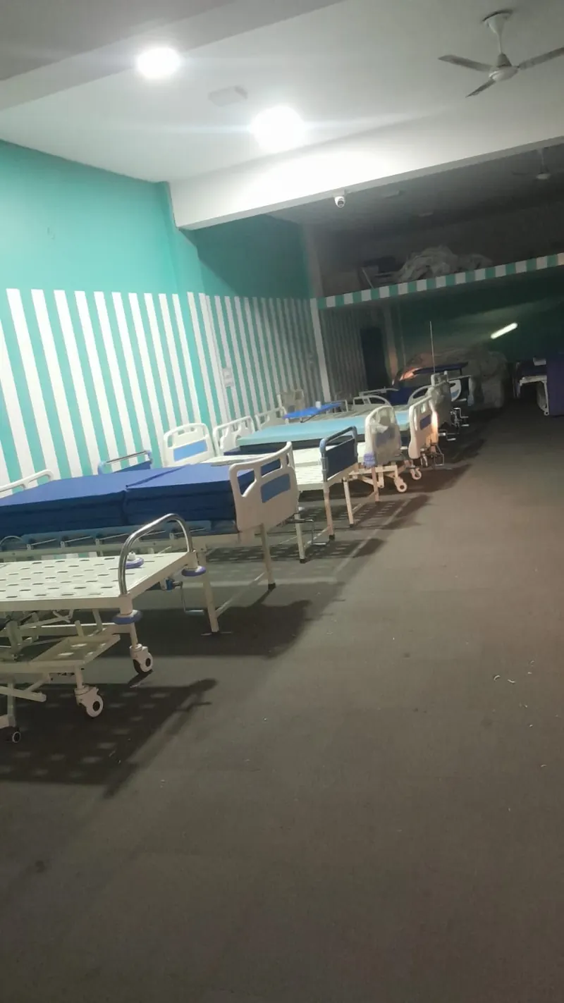 Hospital ward with patient beds and privacy curtains
