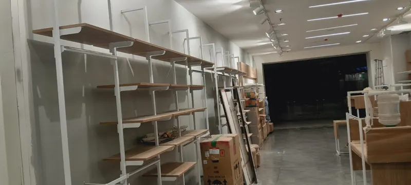Retail store interior with open wooden and metal display shelving