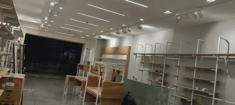 Completed retail store interior with display racks and ceiling lights