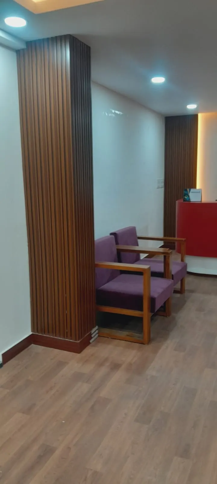 Waiting lounge with wooden wall panelling and upholstered seating